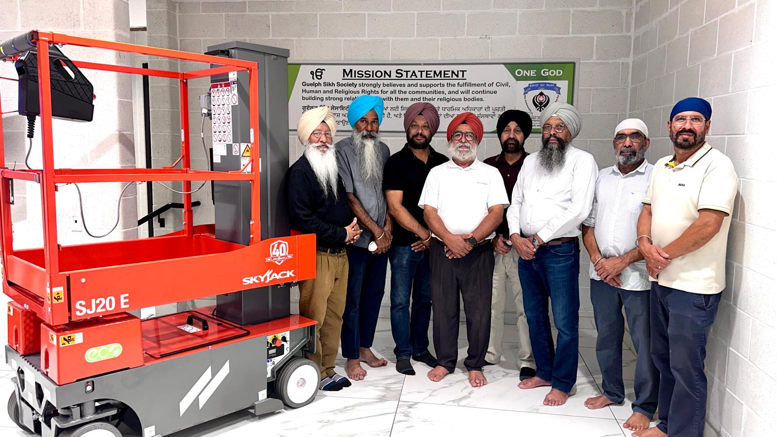 Guelph Sikh Society members with an SJ20 E vertical mast